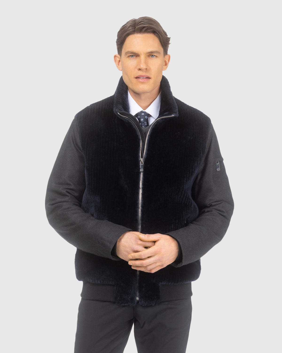 Men's jacket crafted from Loro Piana cashmere and wool with grooved shearling lamb front in navy and black, front view